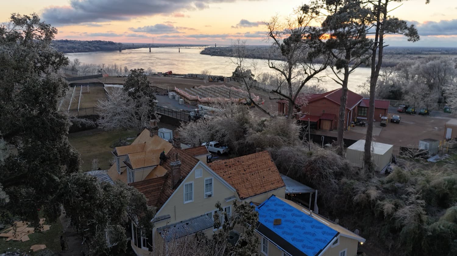 Historic district roof restoration overlooking the Mississippi River at sunset