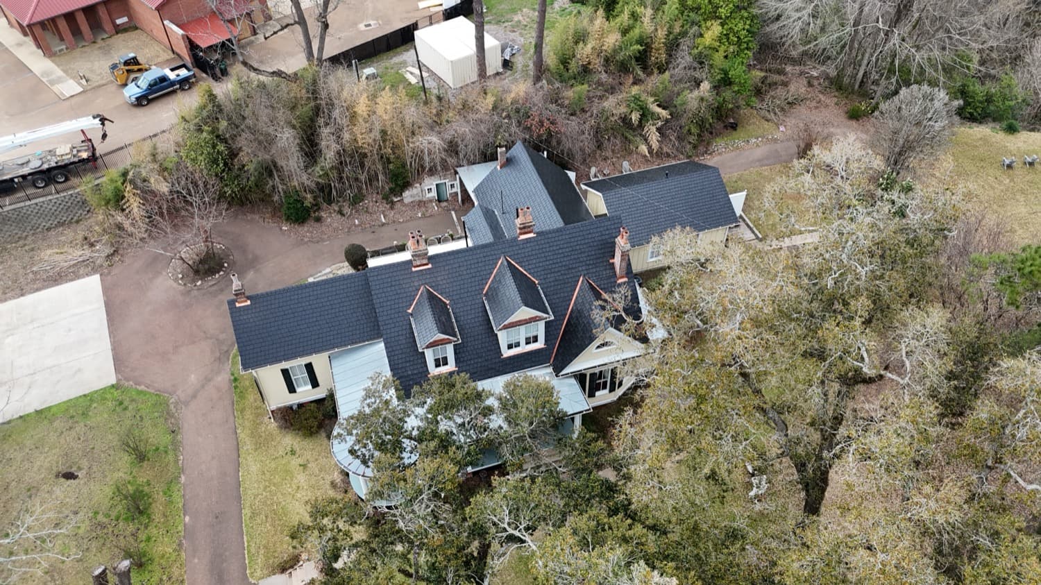 Victorian estate with a dark slate roof and copper-trimmed dormers