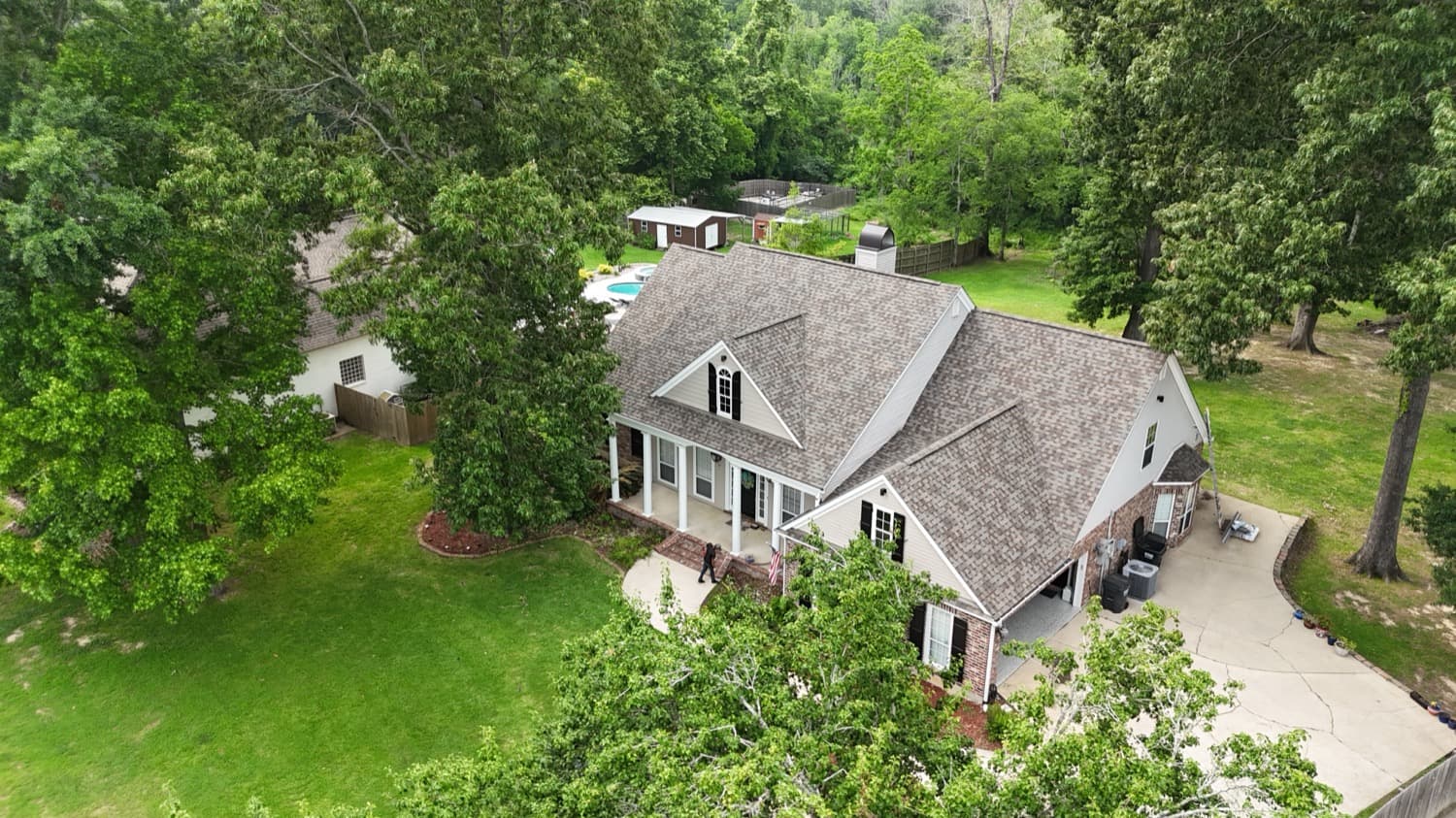 Wooded residential property with a new architectural shingle roof